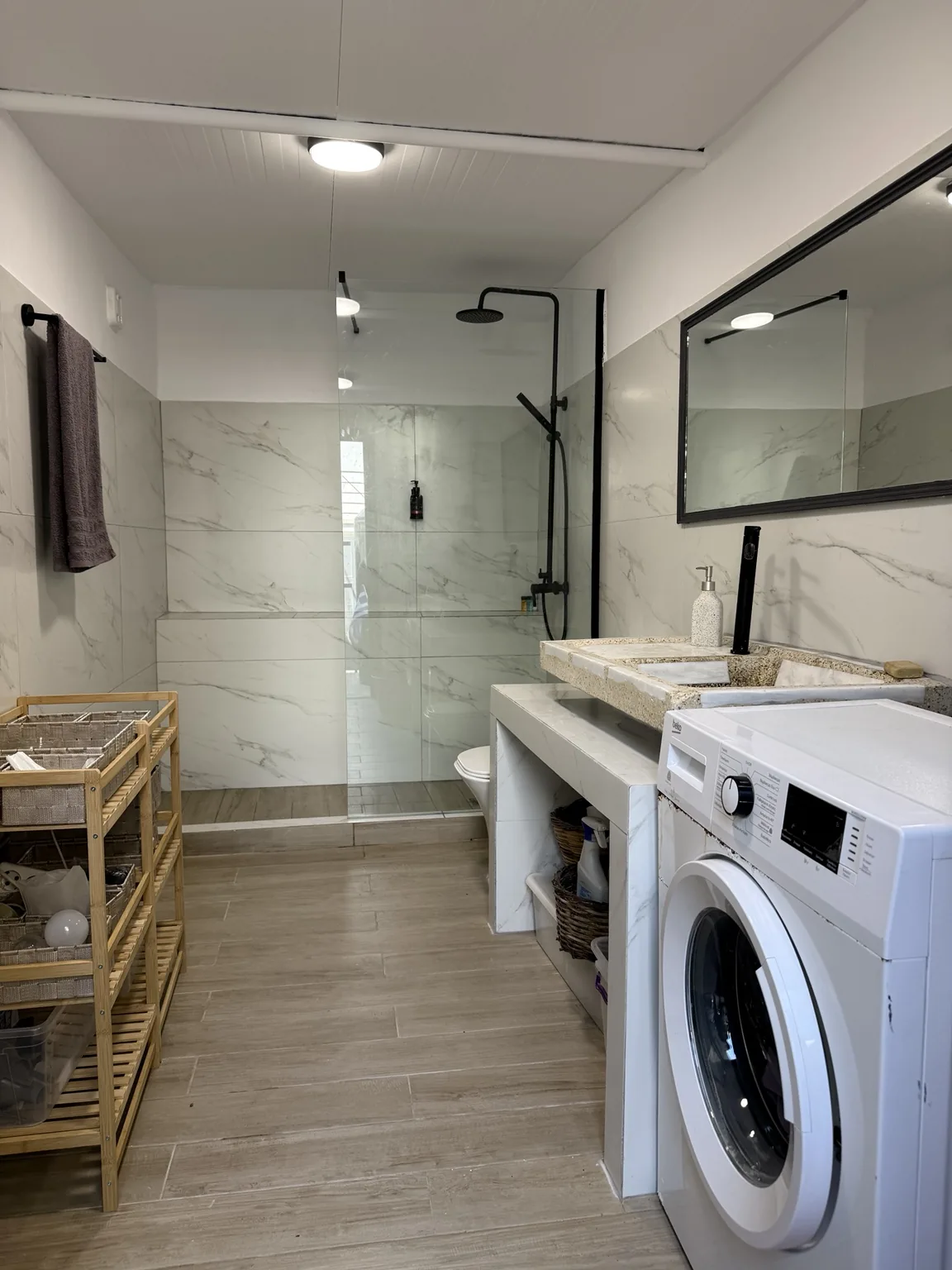 A generous bathroom at St. Paul’s with walk-in shower and washing machine