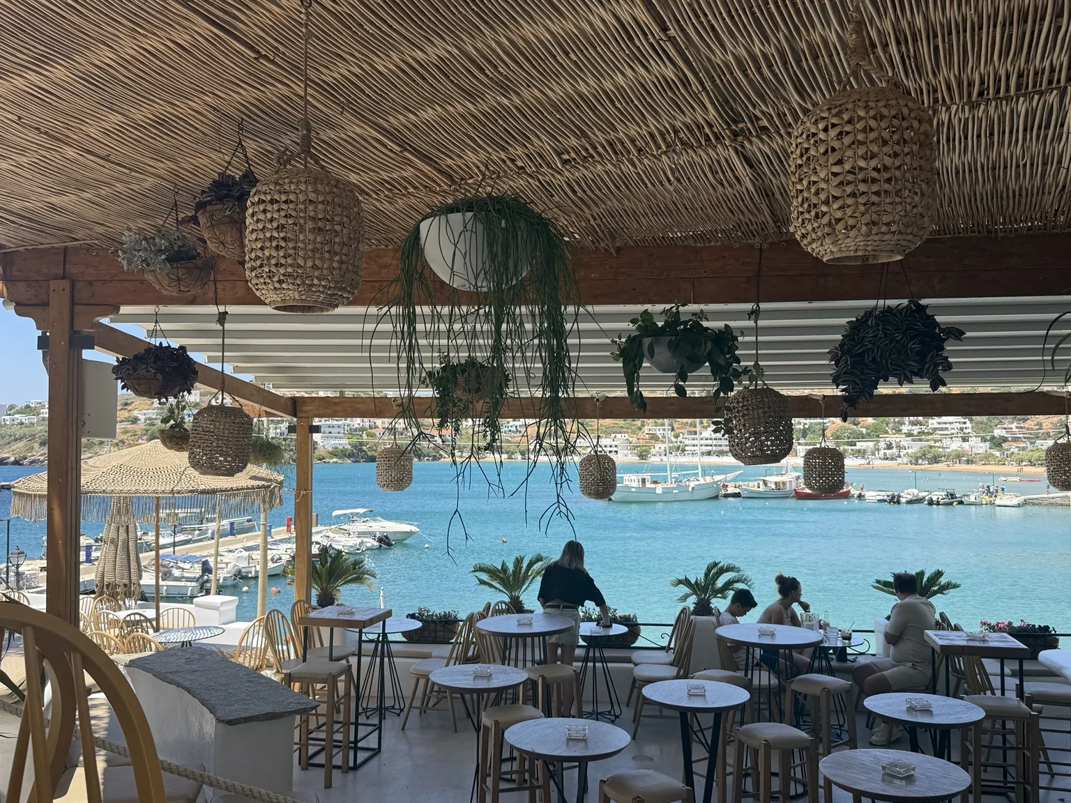 A shaded café terrace overlooking the water in Batsi