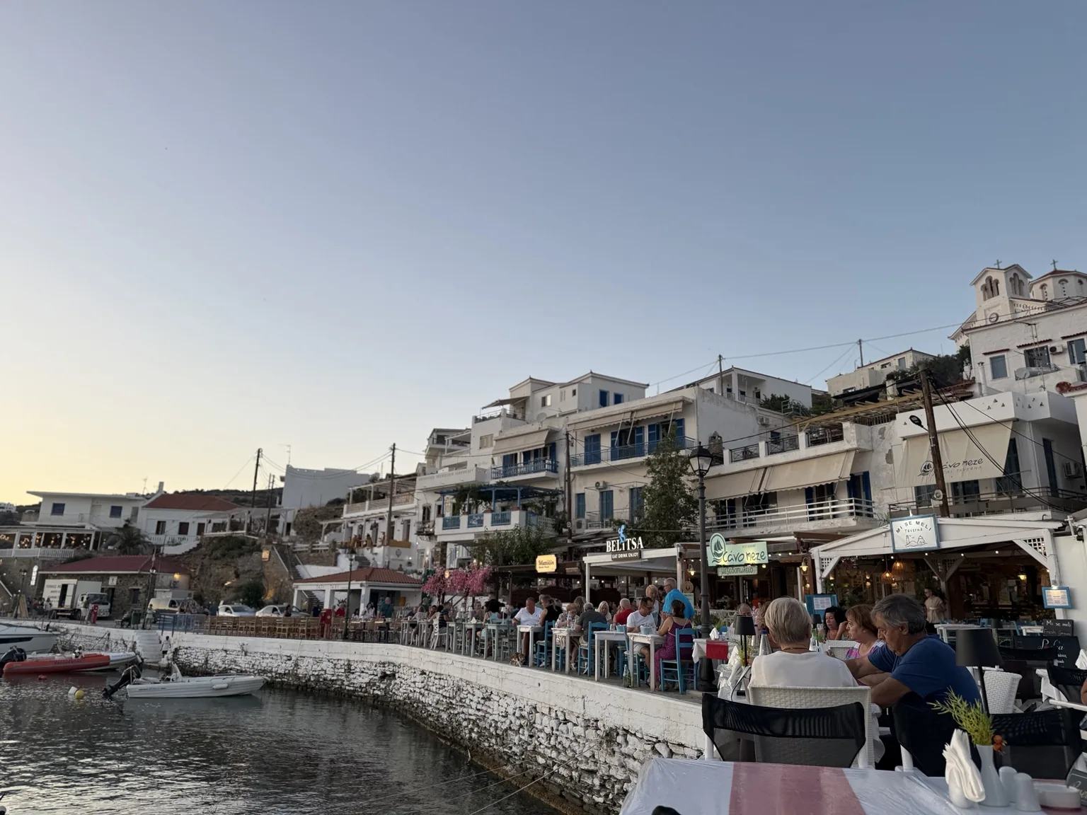 Batsi harbour at evening with restaurants along the water