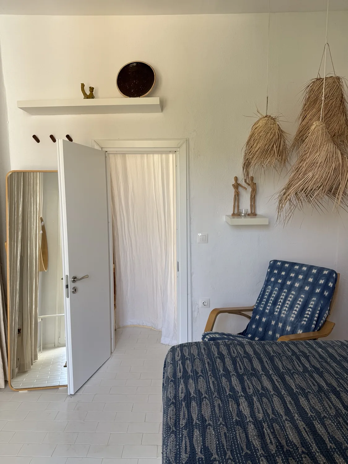 A quiet room with natural fibres, chair and village light