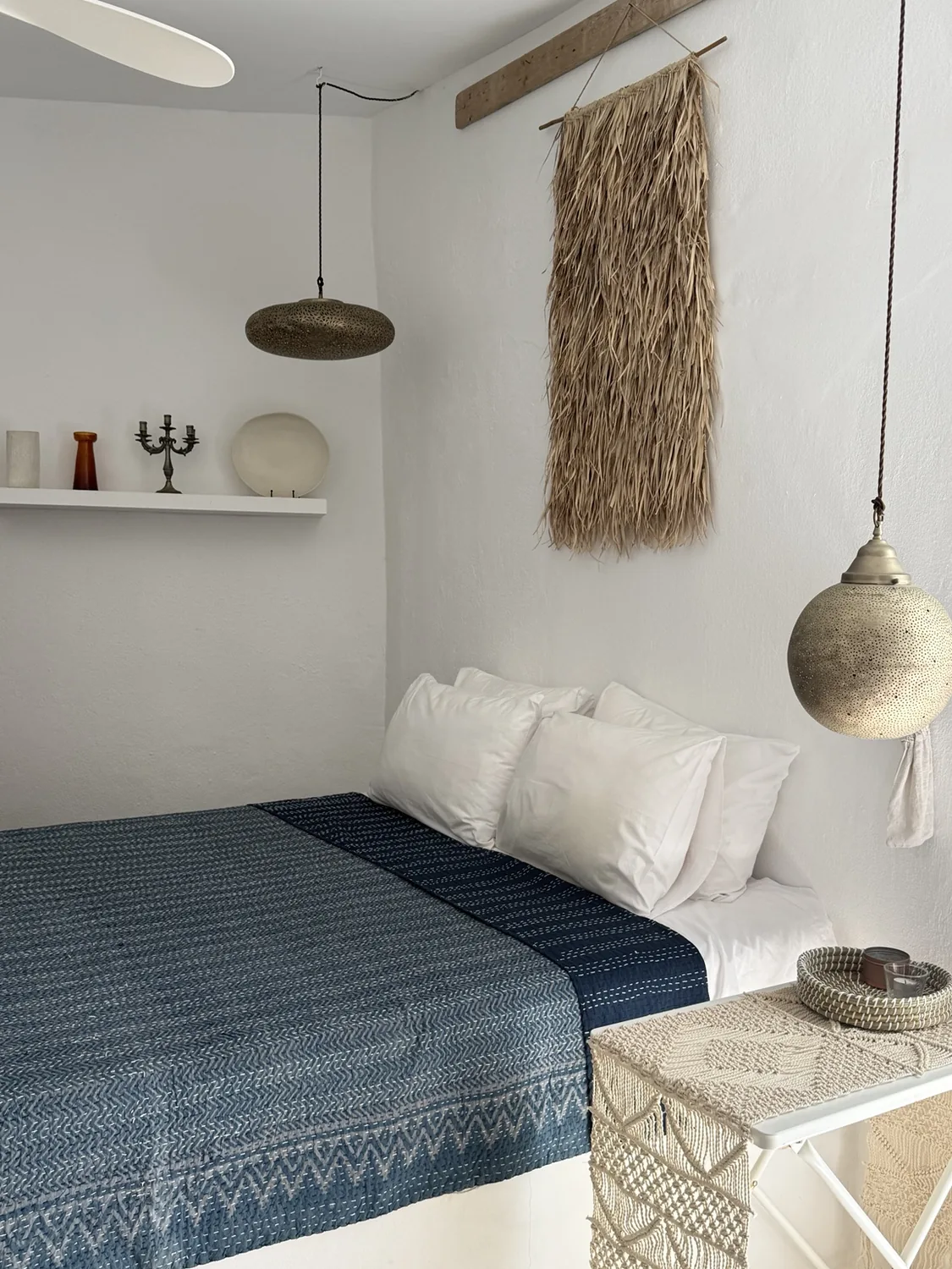 A bedroom at St. Paul’s with natural textiles and hanging lamps